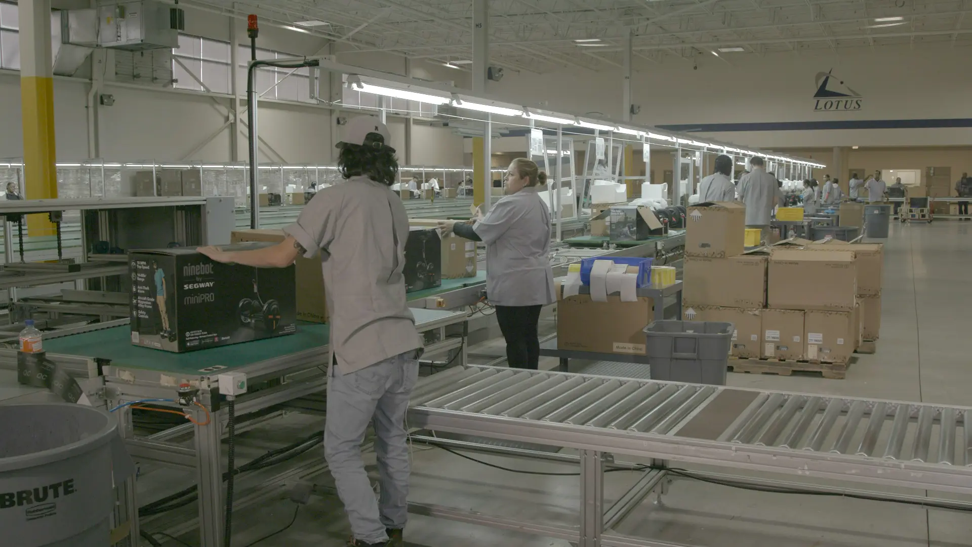Contract manufacturing assembly line with technicians performing electromechanical assembly